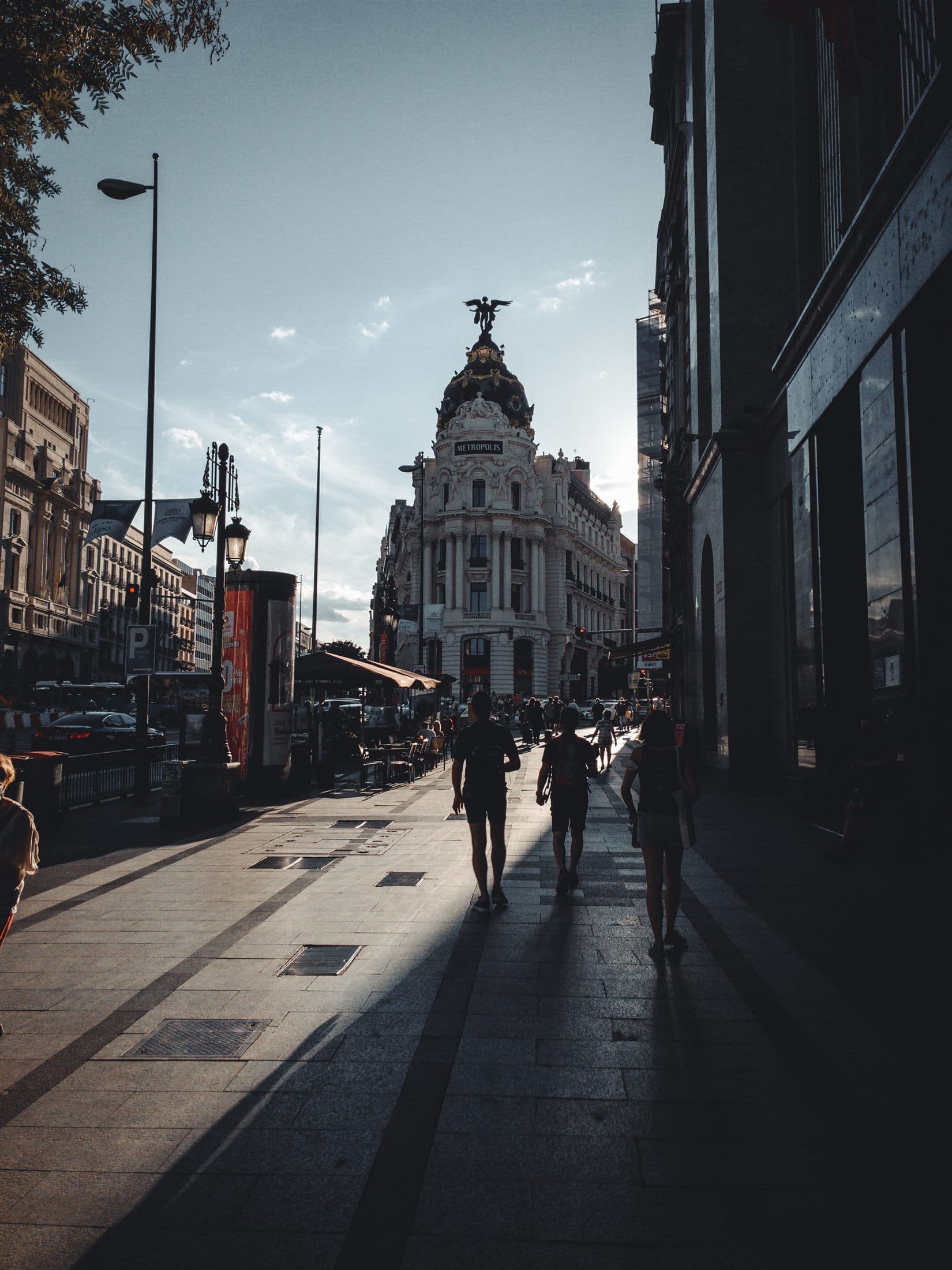 The Metropolis Building in Madrid against a bright blue sky.