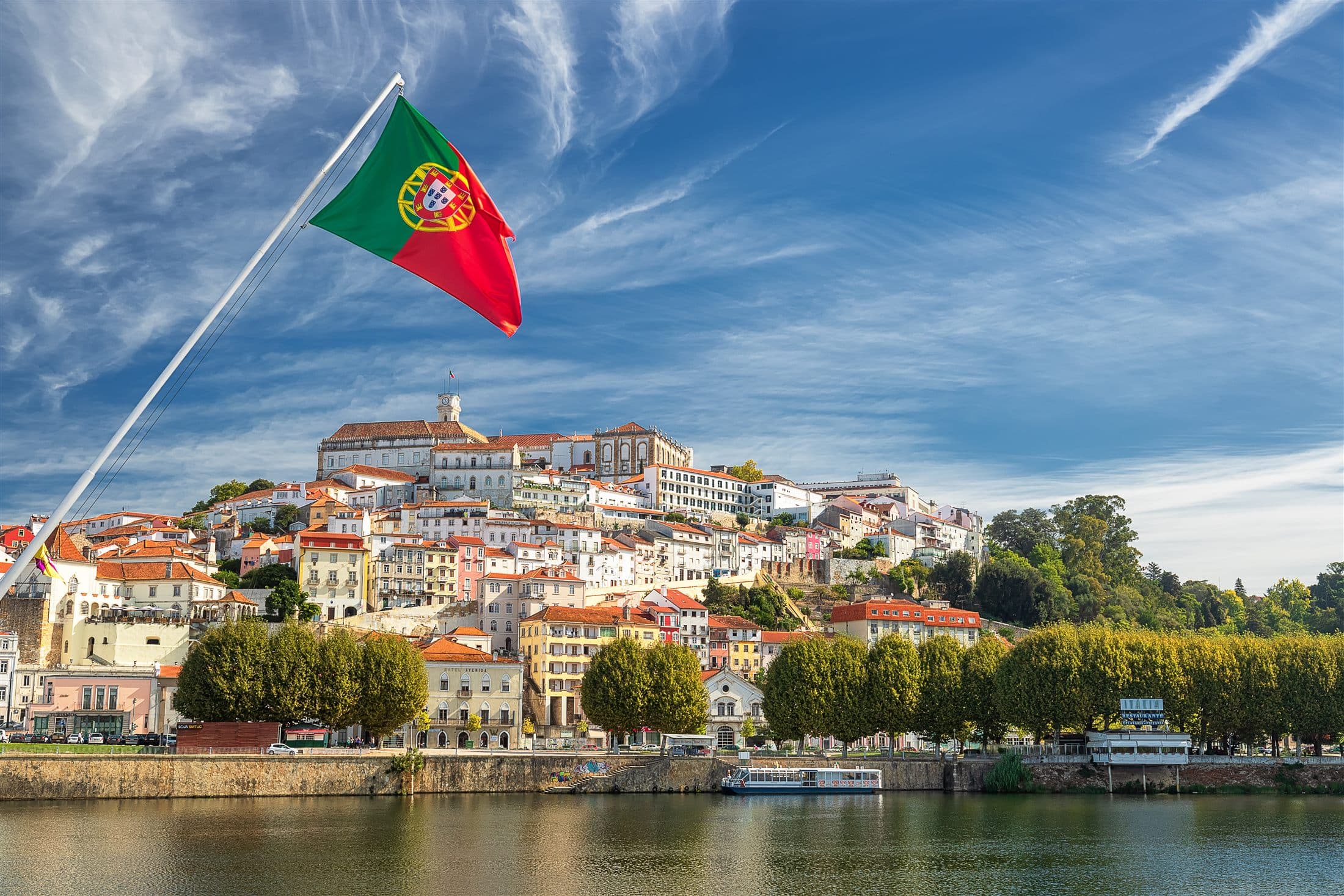 Panoramic view of Coimbra's old university city and terracotta rooftops.